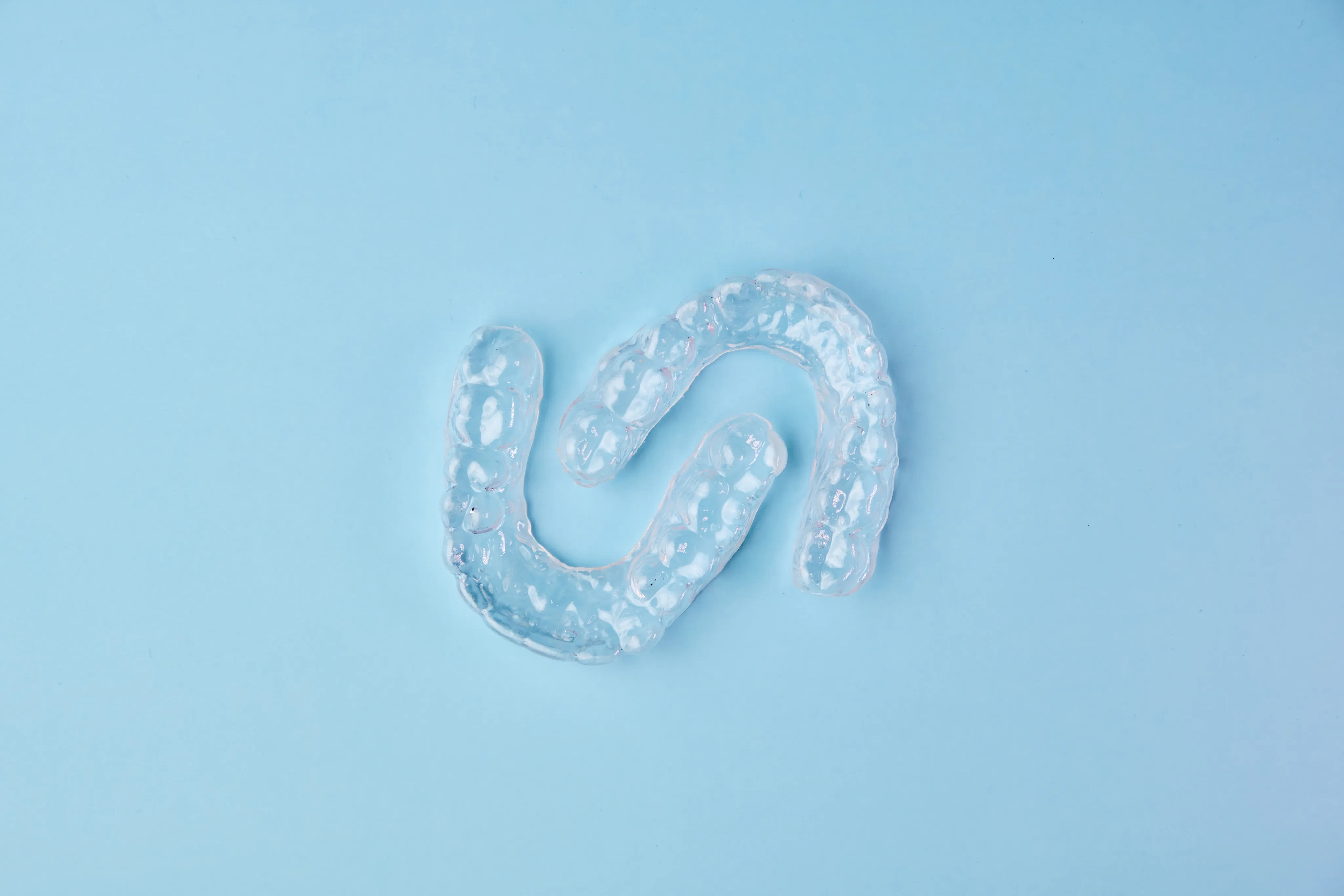 Clear aligners on a blue background
